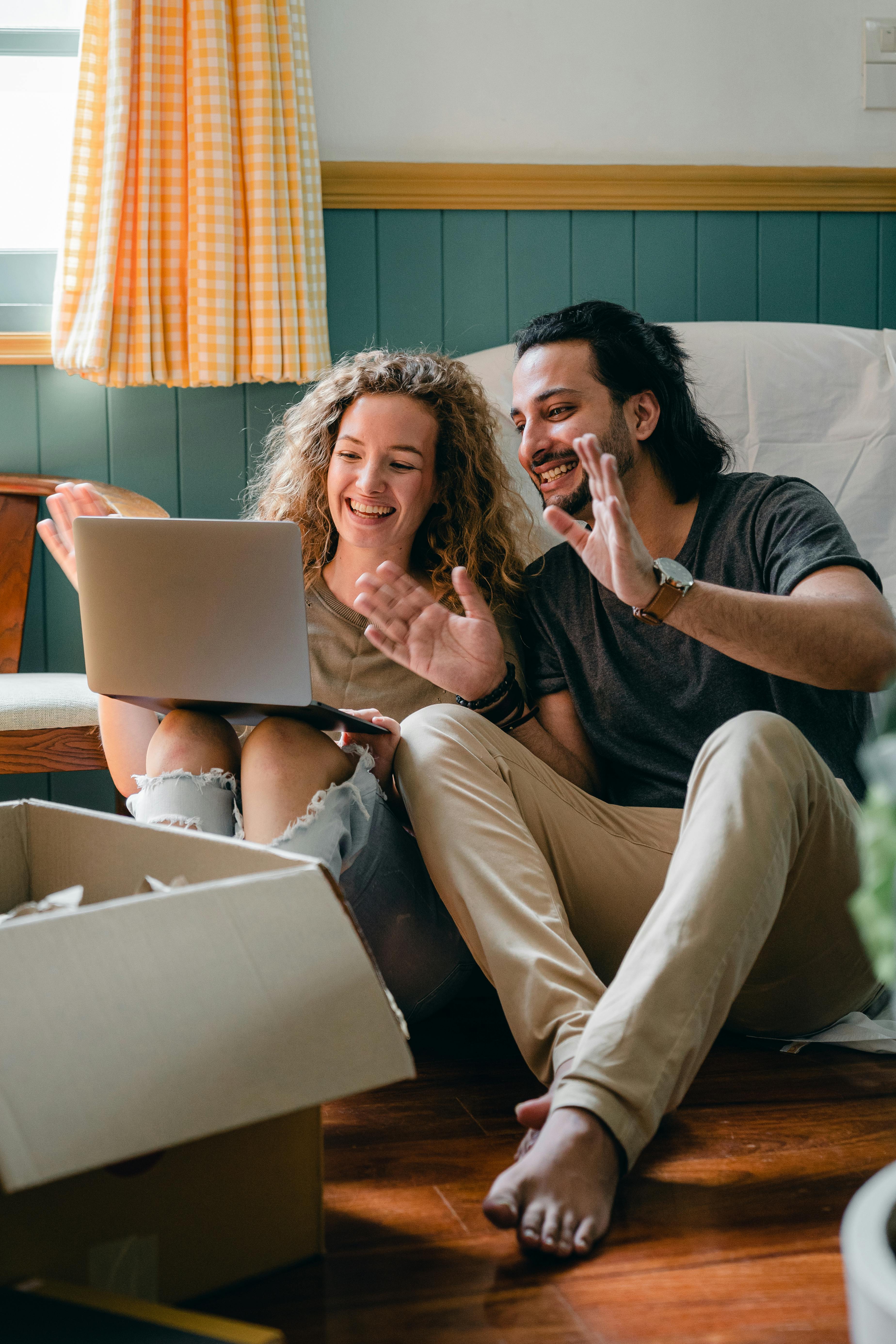 cheerful couple having video chat via laptop