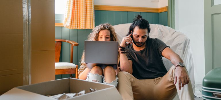 Couple comparing costs for the best time to move in Phoenix