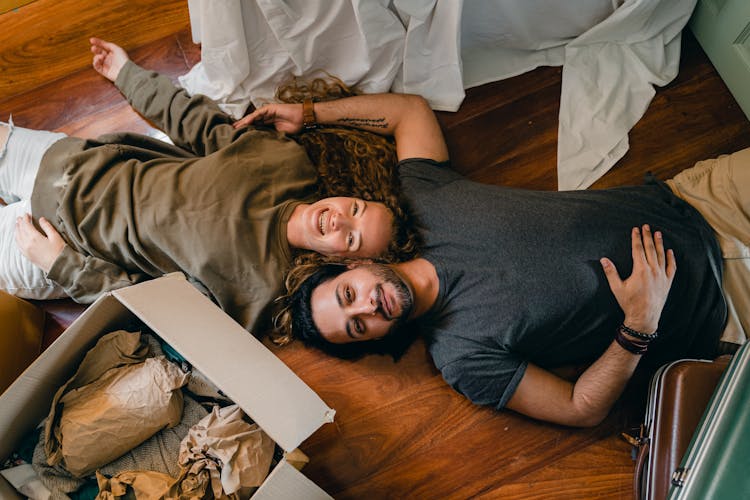 Cheerful Couple Lying On Floor And Laughing