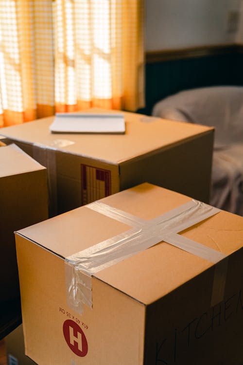 Free Carton boxes in living room near blinded widow Stock Photo