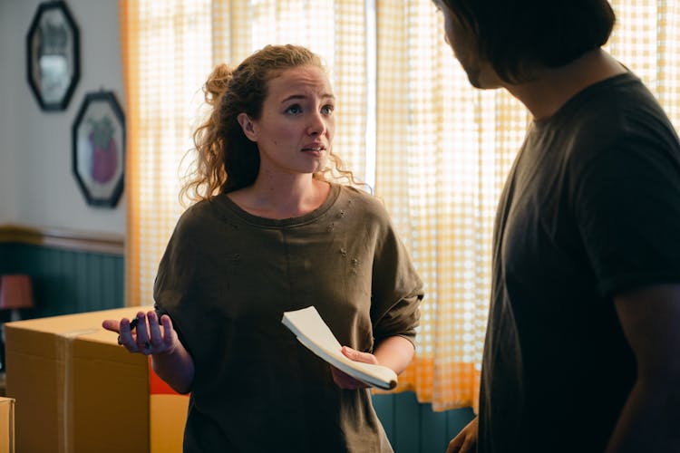 Couple Talking While Moving In New Apartment