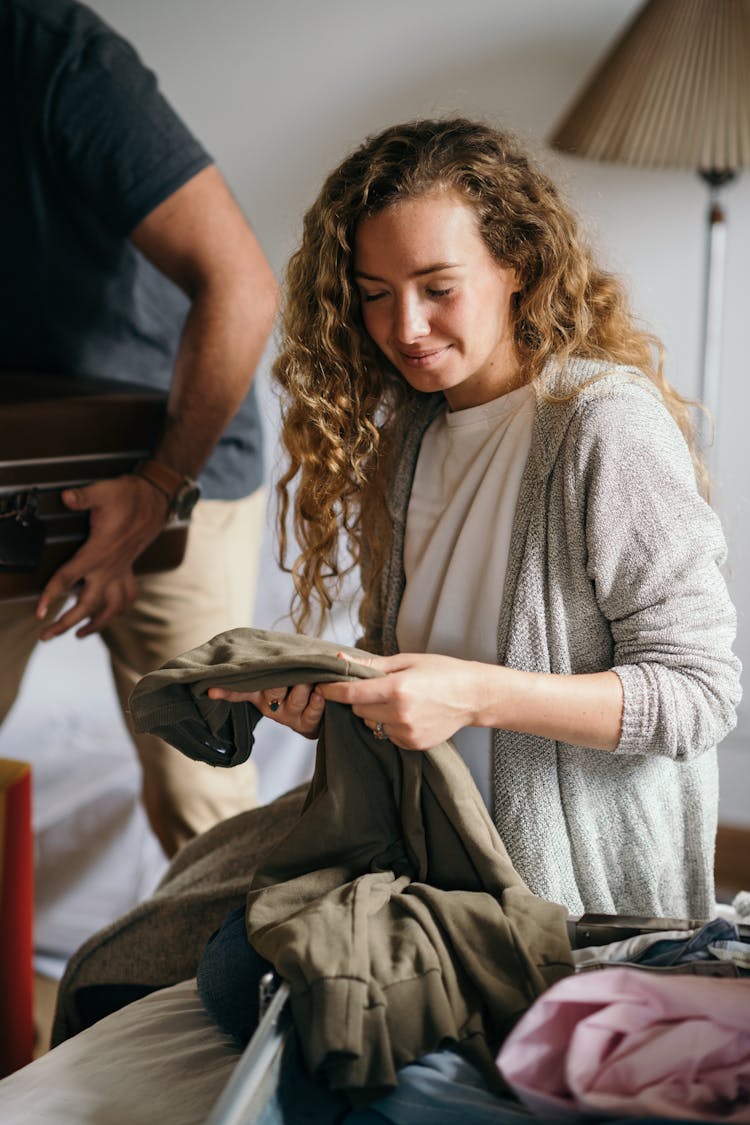 Couple Packing Bags While Getting Ready For Vacation