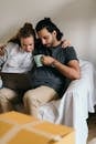 Multiethnic couple surfing net on laptop in new house