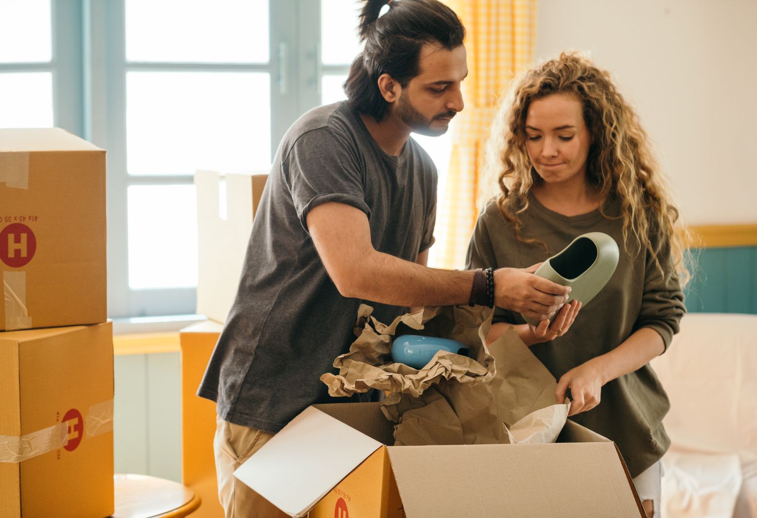 Locking — professional packers wrapping and boxing belongings