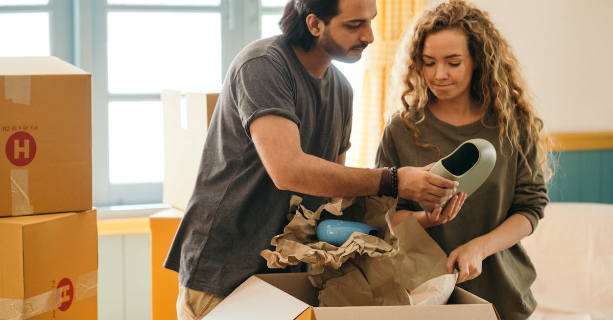 A couple unpacking boxes in a new home, sharing belongings and organizing.