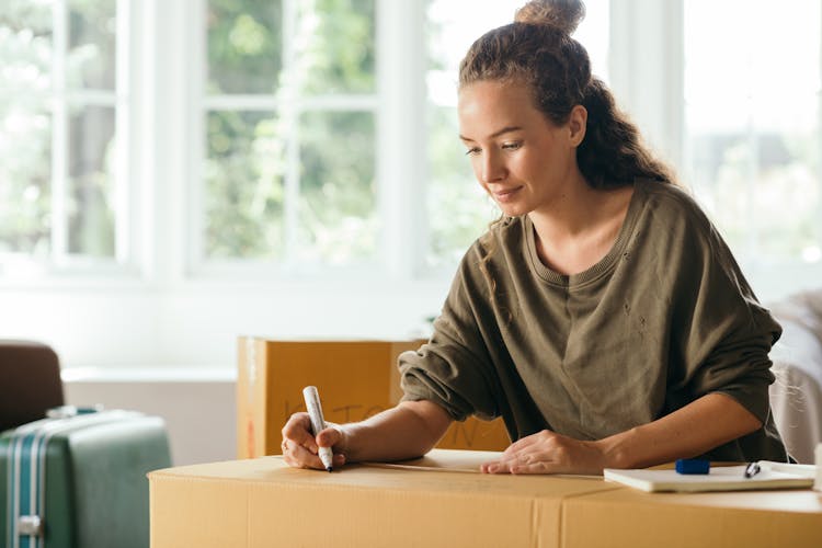 Pleasant Woman Preparing Stuff For Moving