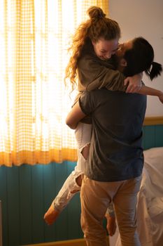 Loving diverse couple having fun in new own home