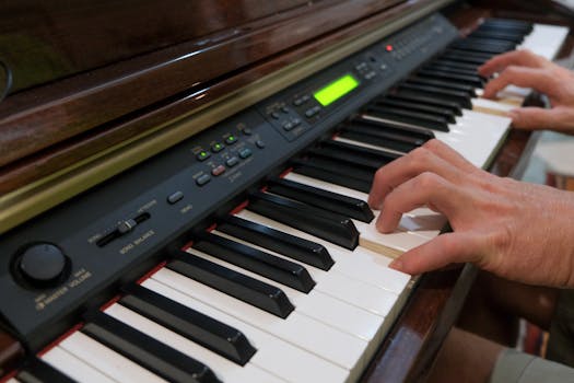 Close-up of hands playing an electric piano indoors, focusing on keys and musical performance.