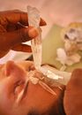 Crop ethnic master transferring crystal energy to female client