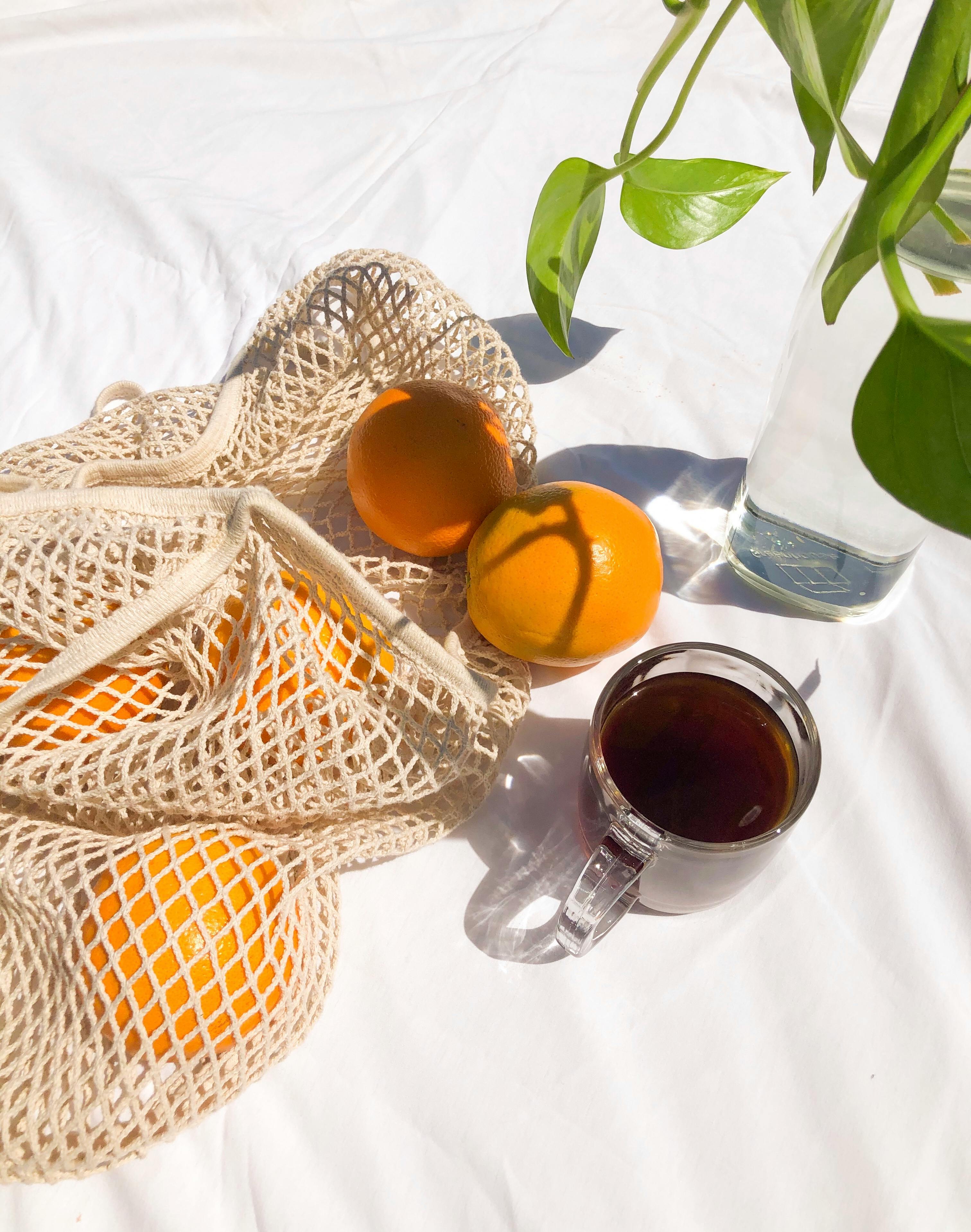 Black tea with fresh oranges and vase with plant · Free Stock Photo