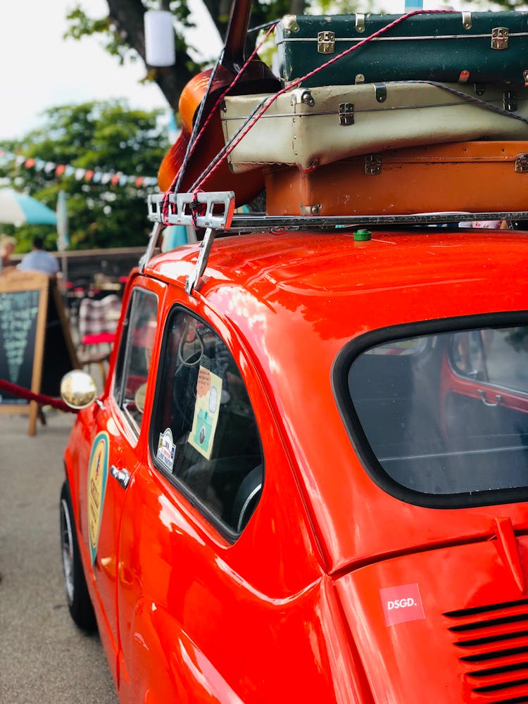 Luggage On Top Of Red Car