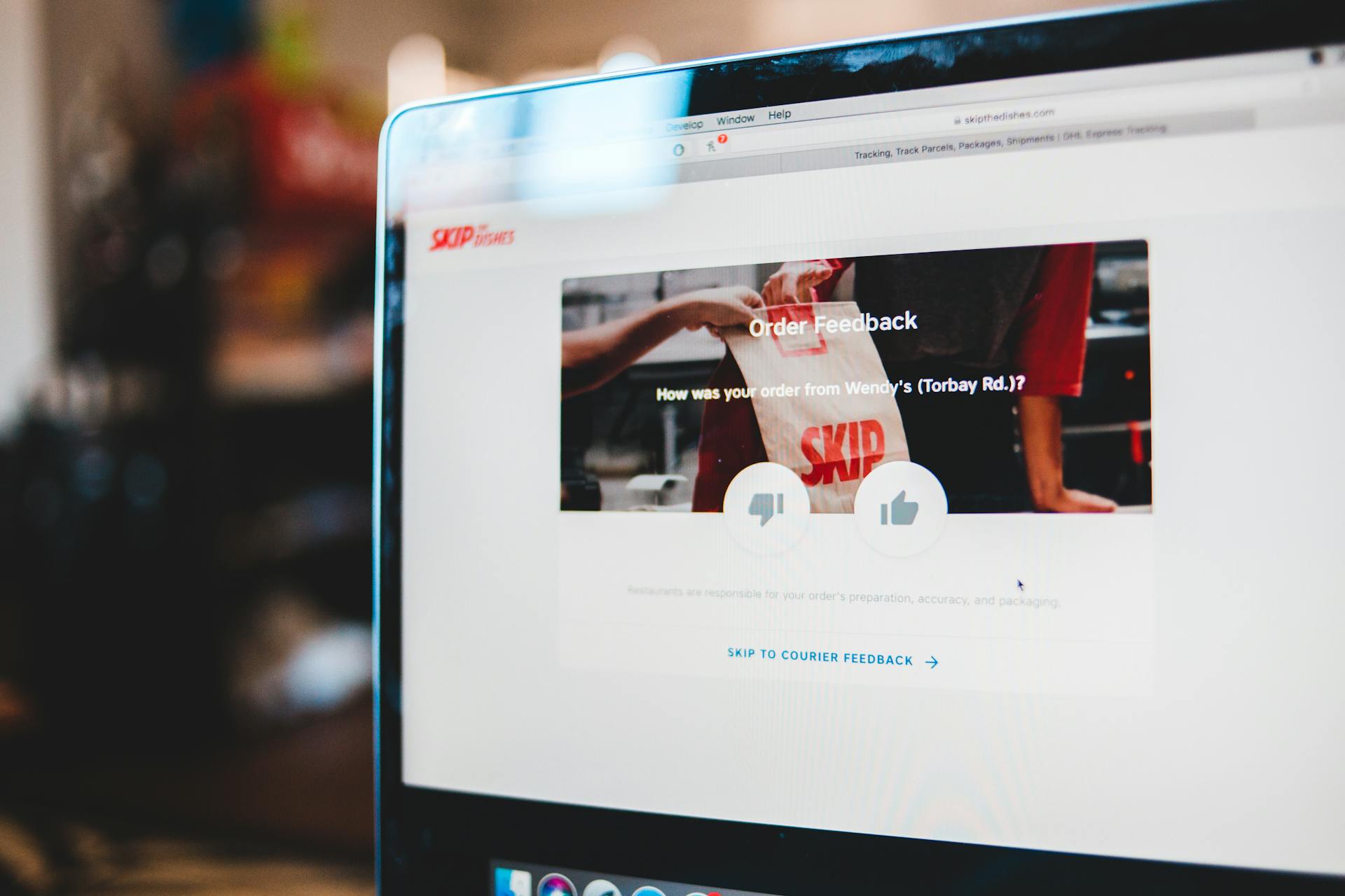 Online feedback form interface on laptop screen illustrating user interaction with delivery service.