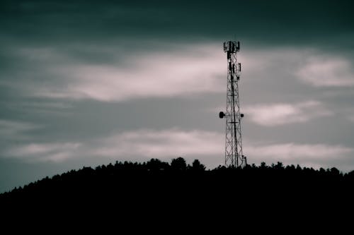 Silhouette of Telecommunications Tower under Night Sky