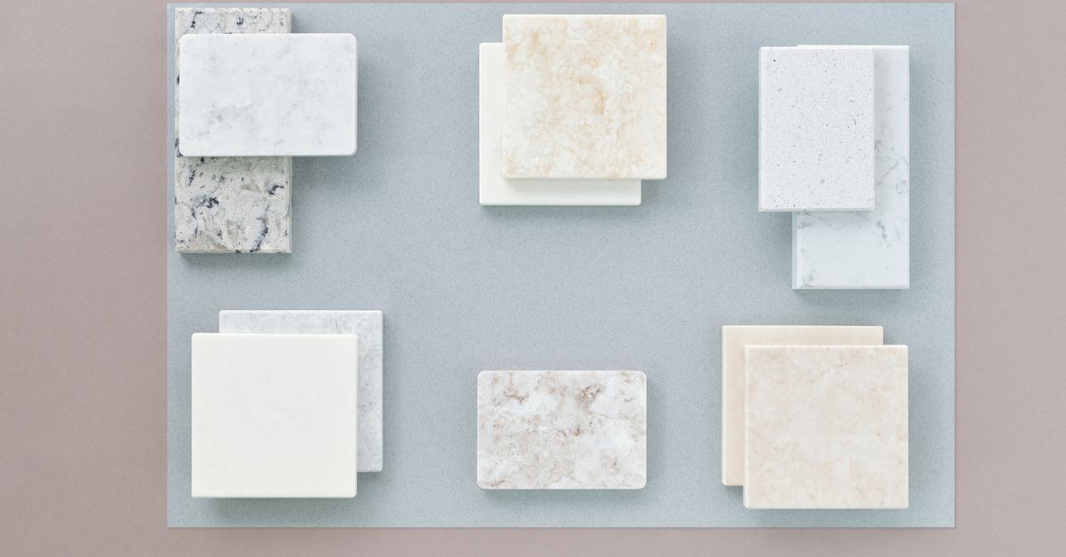 Flat lay image of various marble tile samples arranged on a neutral surface, perfect for design projects.