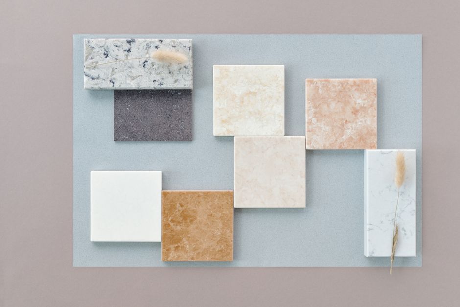 Photo by Edward Jenner on Pexels A flat lay of various marble tiles on a neutral background, showcasing diverse textures and colors.