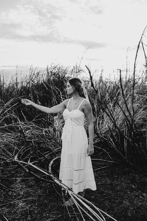 Sensual woman standing in field in summer day
