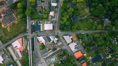 Aerial view suburban area with residential cottages and commerce buildings