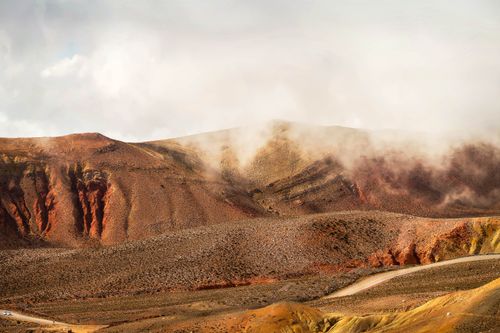 Free Amazing landscape of rocky majestic canyon of red color under light mist on foggy day Stock Photo