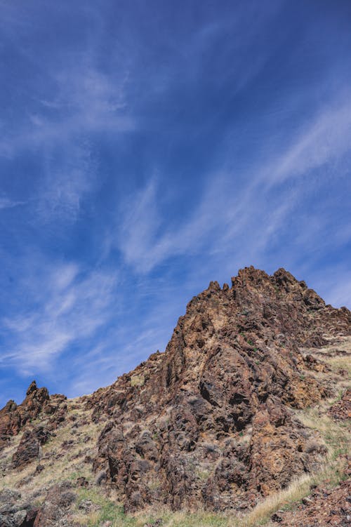 Rocky hill peak against blue sky