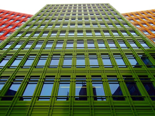 бесплатная Фото зеленого многоэтажного дома под низким углом Стоковое фото