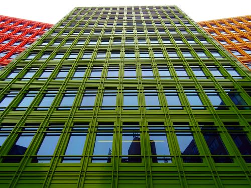 Free Low angle view of colorful urban building facade with reflective windows in modern architectural style. Stock Photo