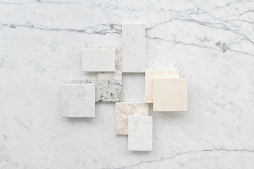 Free Aesthetic flatlay of diverse marble tiles on a light stone background for design inspiration. Stock Photo