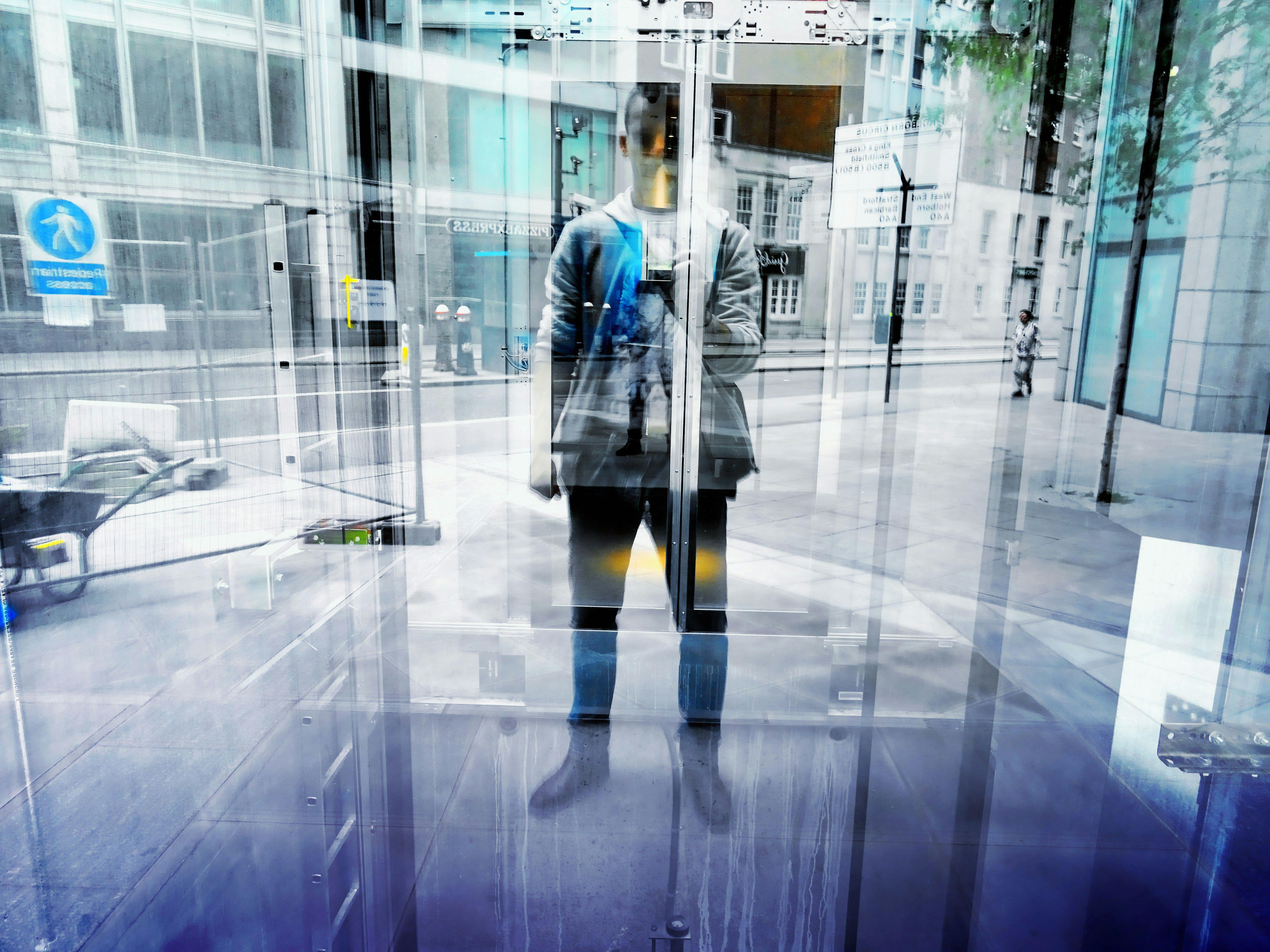 Man Standing in Front of Glass Door and Taking Selfie \u00b7 Free Stock Photo