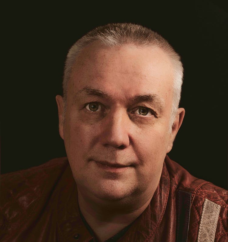 Portrait Of Positive Middle Aged Man In Studio