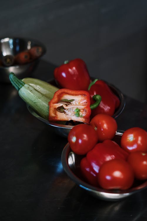 Red and Green Bell Peppers on Stainless Steel Bowl
