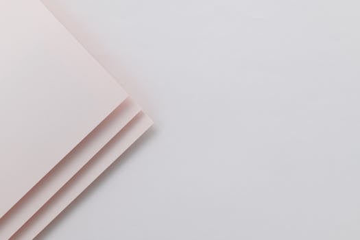 A minimalist design featuring soft pink paper with a subtle texture, ideal for backgrounds.