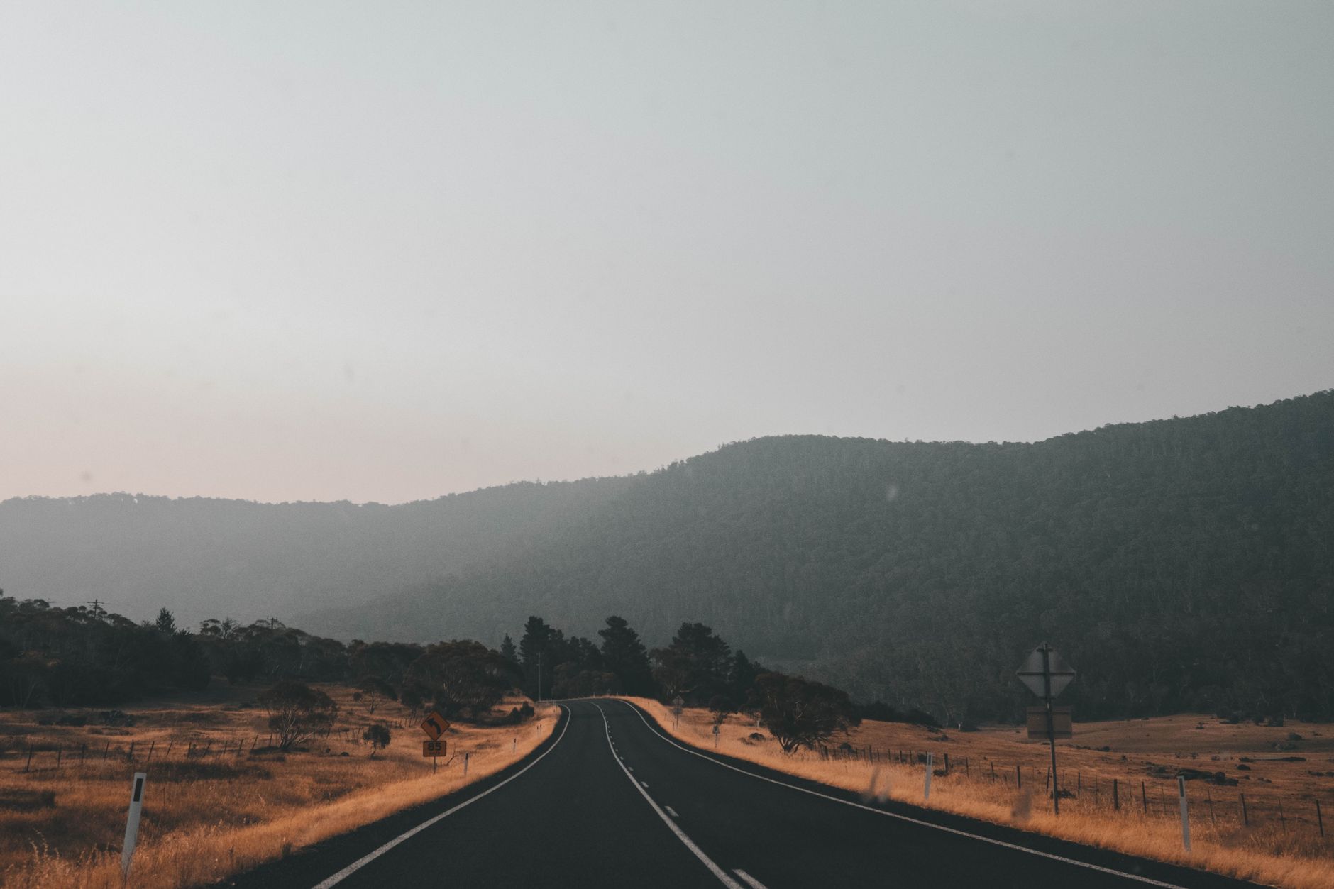 Open regional road in New South Wales country, the sort of drive that only turns into spending when people stop and stay