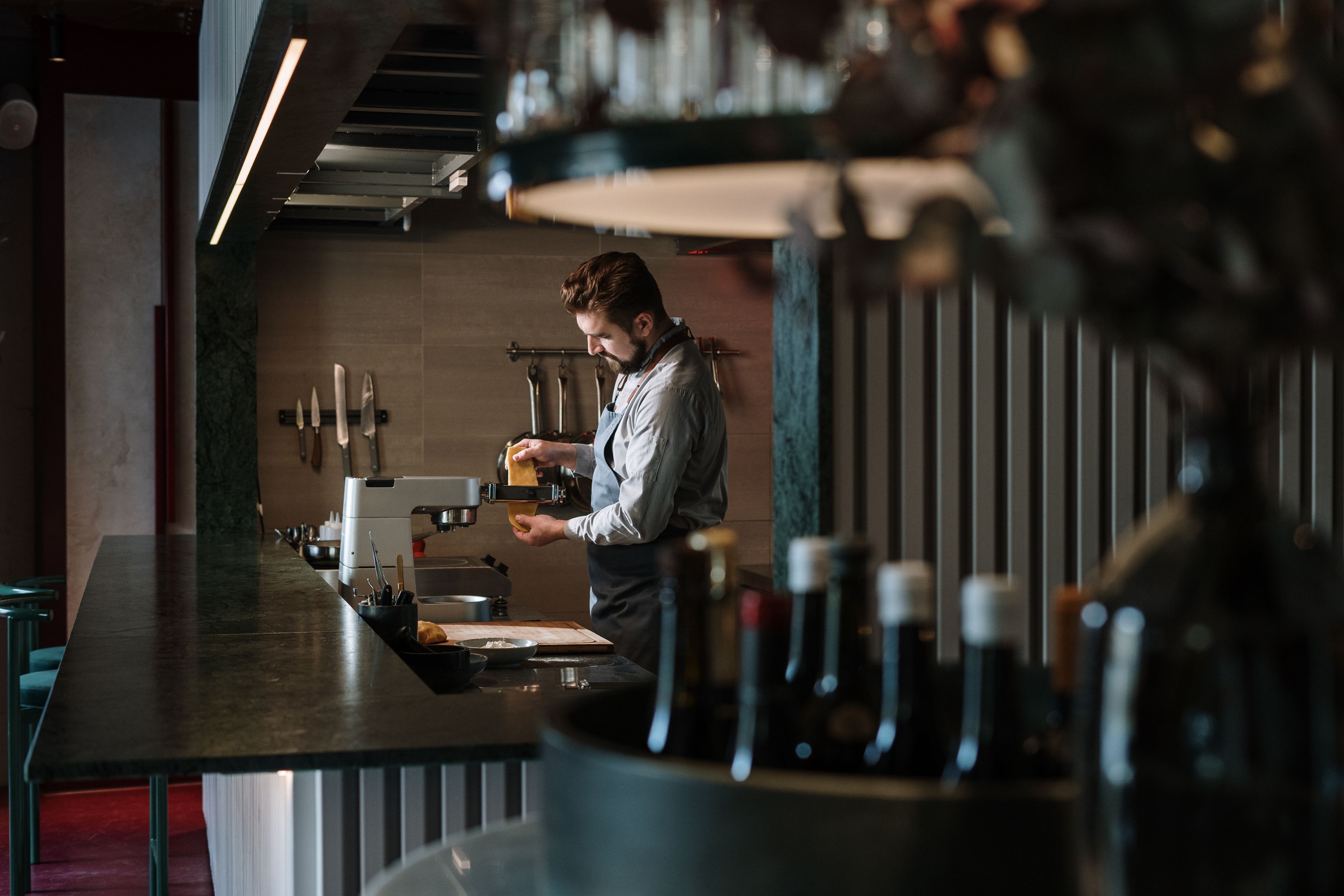 Cuisinier préparant un plat dans une cuisine de restaurant contemporaine à l'espace contraint