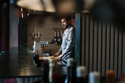 A skilled chef preparing ingredients in an industrial kitchen setting.