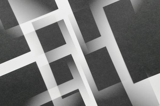 Stylish abstract geometric design with overlapping black and white rectangular patterns.