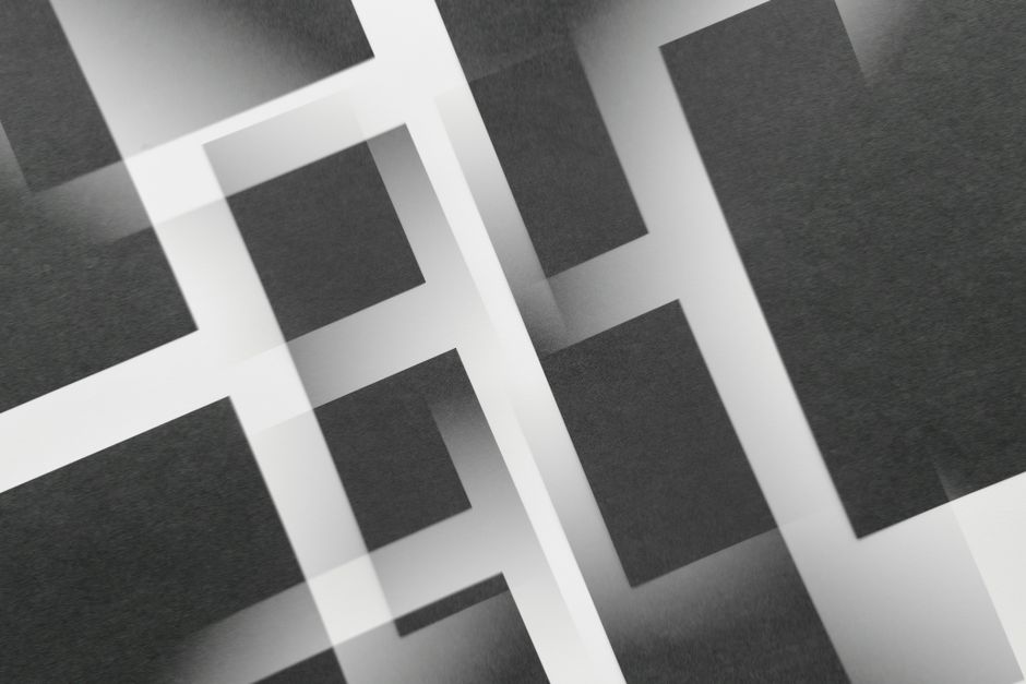 Stylish abstract geometric design with overlapping black and white rectangular patterns.