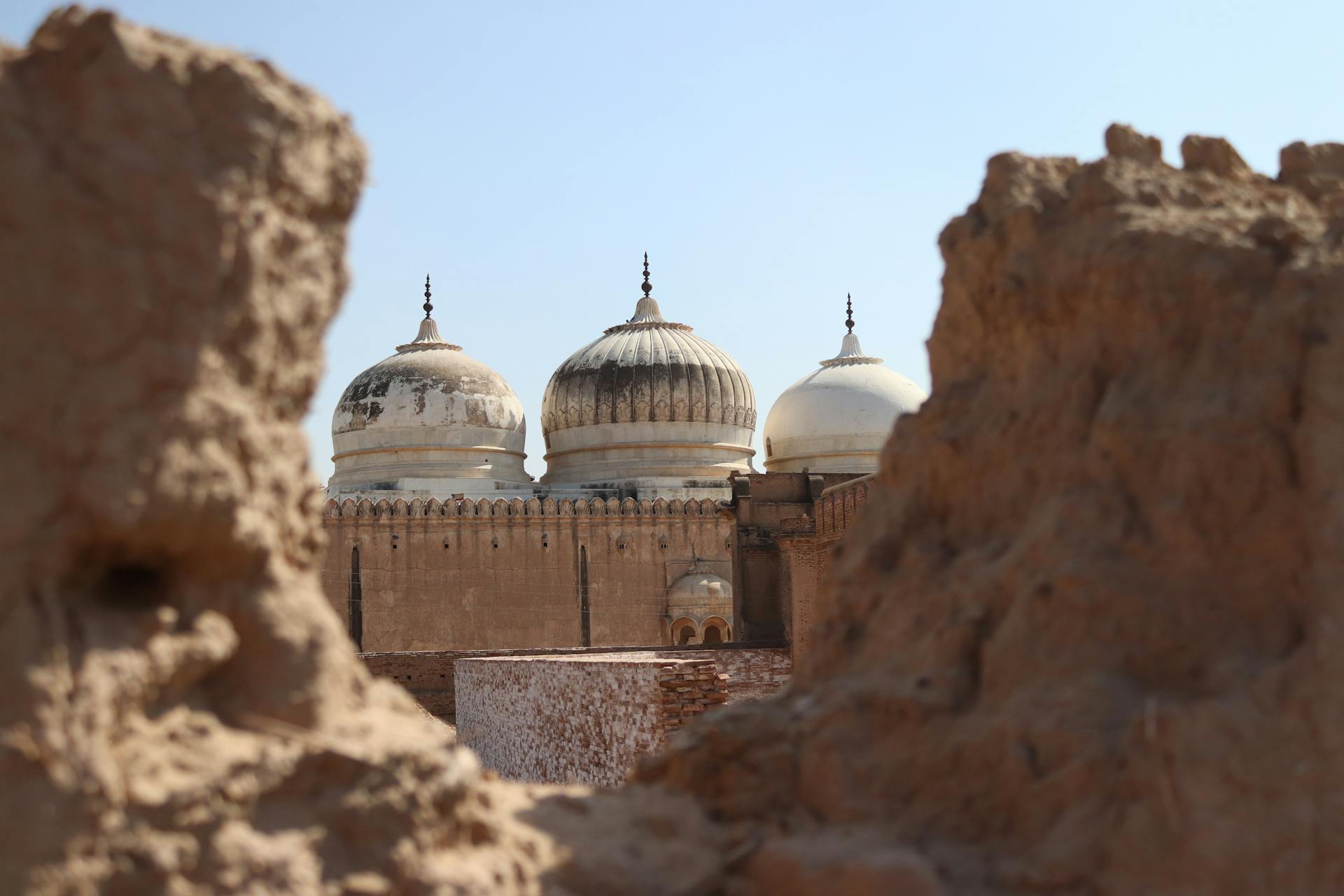 Domes of ancient Abbasi Mosque located in arid desert on territory of Derawar Fort in Pakistan