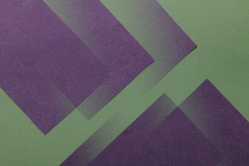 Multiple Overlay Patterns of a Purple Design on Green Surface