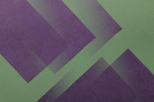 Modern abstract image featuring overlapping purple shapes on a green background, perfect for creative design use.