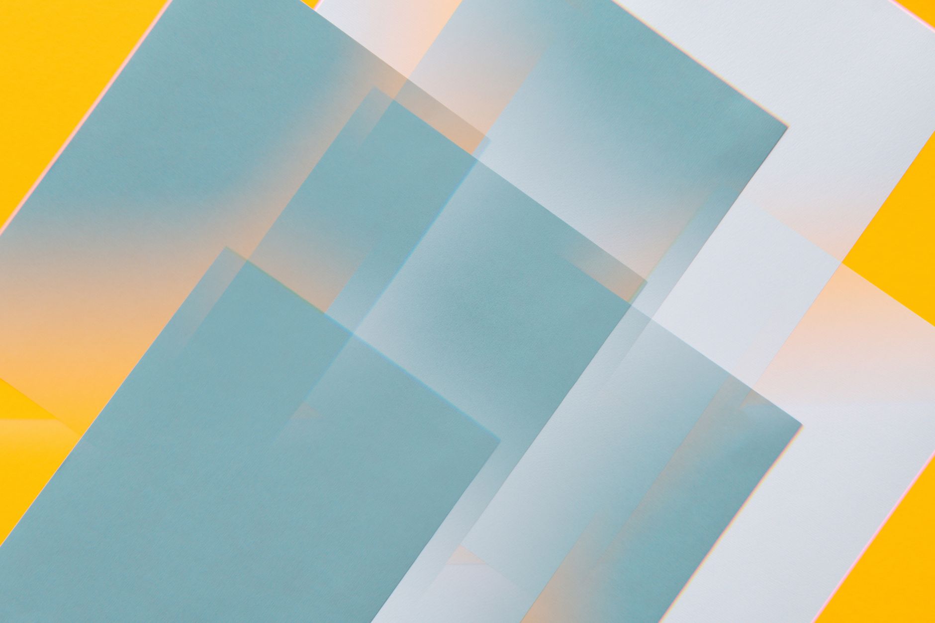 Creative abstract geometric design with overlapping teal and yellow rectangles.