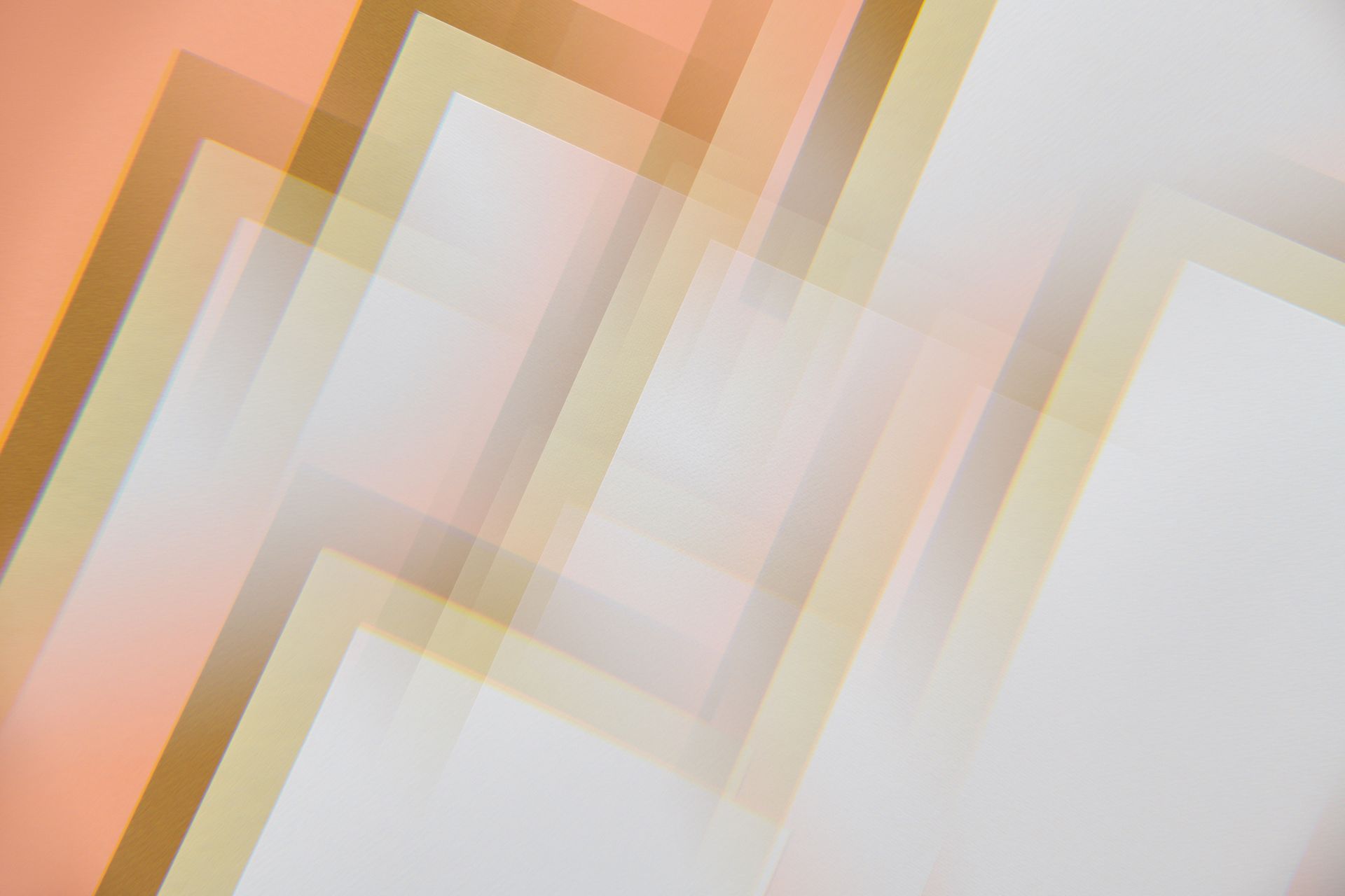 An abstract image featuring overlapping geometric shapes creating a modern, soft pastel pattern.