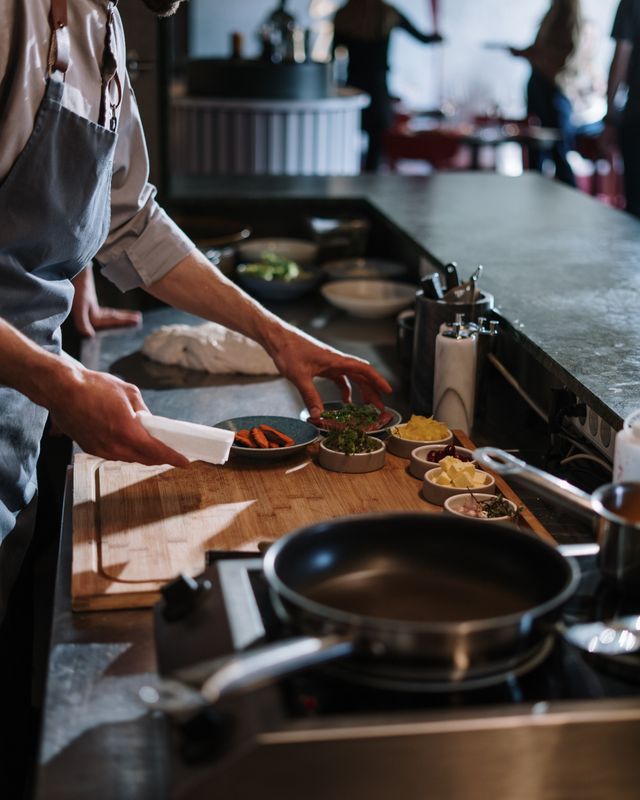 Chef organizing ingredients at a kitchen counter