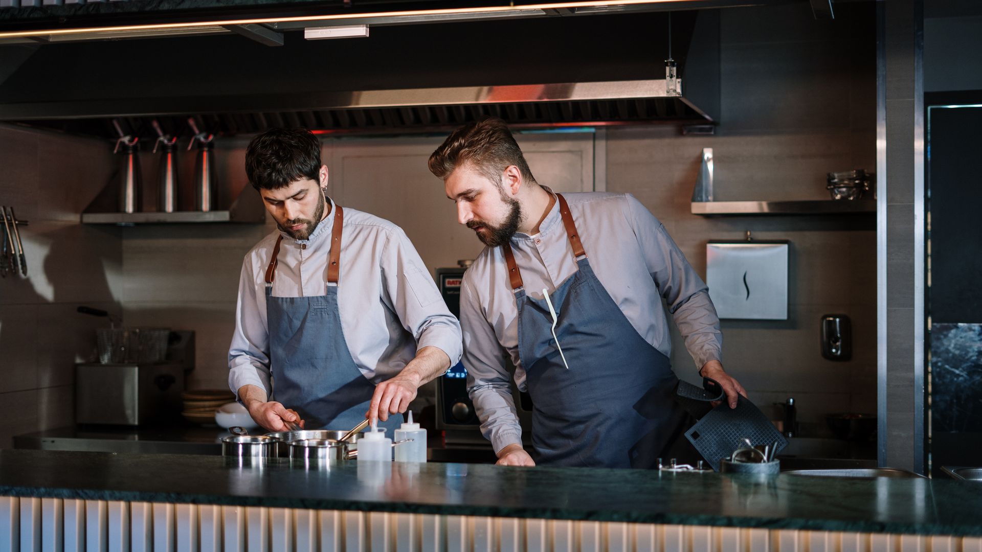 Commercial kitchen chefs working — restaurant and catering electrical equipment testing