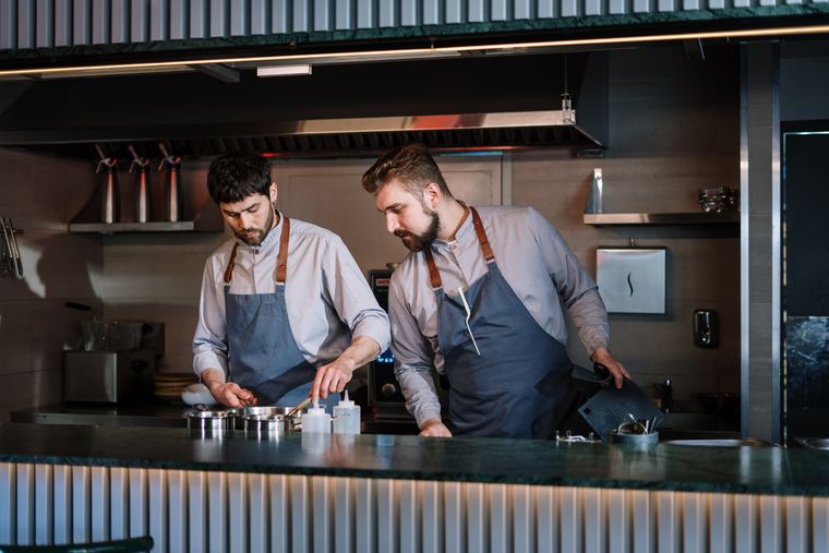 Chefs preparing a service in an open kitchen — cottonbro studio on Pexels