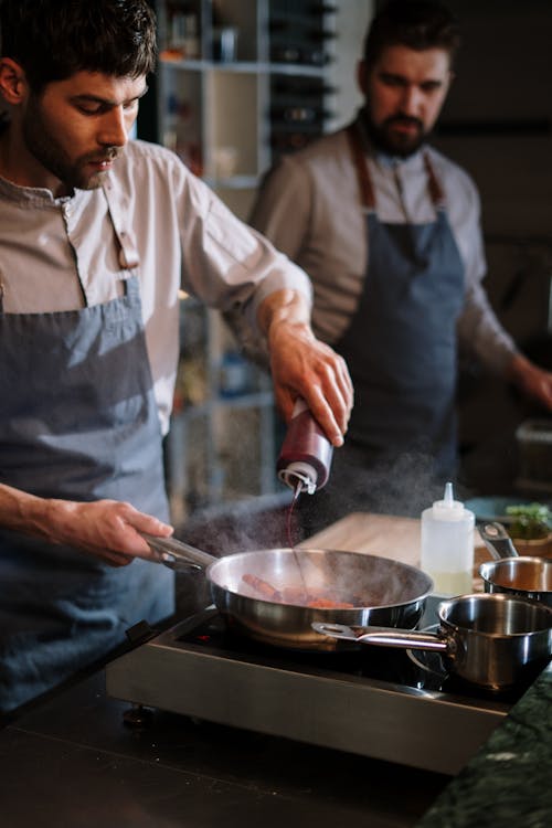 Man in White Button Up Shirt Holding Stainless Steel Cooking Pot