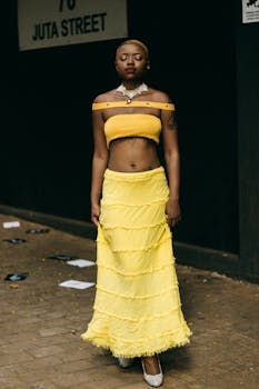 Stylish woman in a yellow outfit posing on Juta Street, Johannesburg.