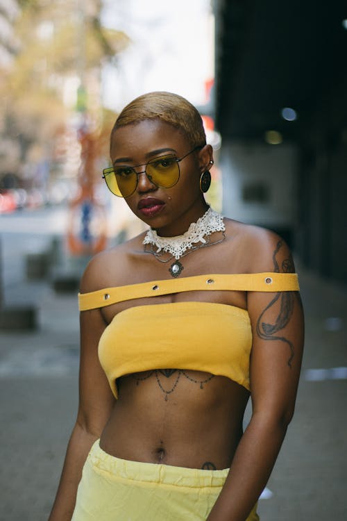 Close-Up Shot of a Woman in Yellow Outfit Wearing Yellow Sunglasses