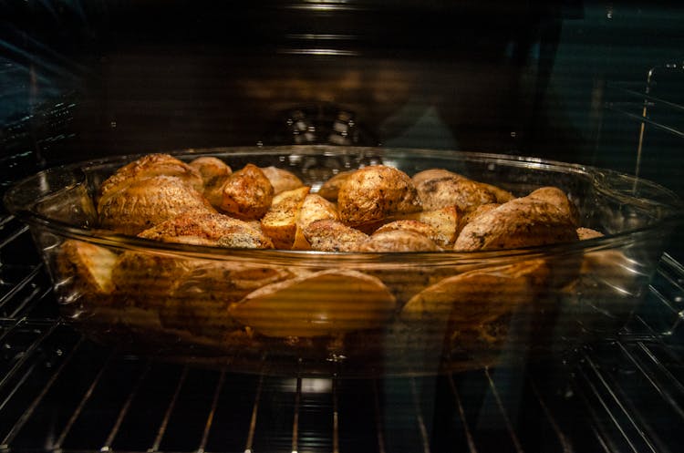 Delicious Spicy Potatoes In Glass Dish In Oven