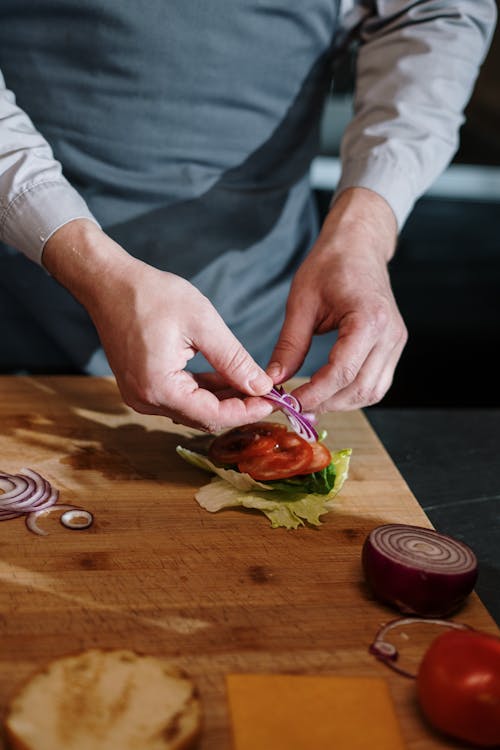 Person Holding Red and Green Vegetable