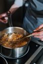 Person Holding Stainless Steel Cooking Pot