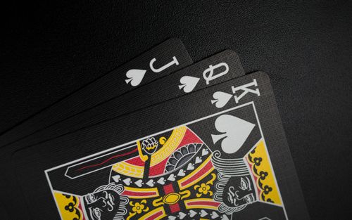 Free Close-up of black playing cards with focus on the King of Spades in a spade hand. Stock Photo